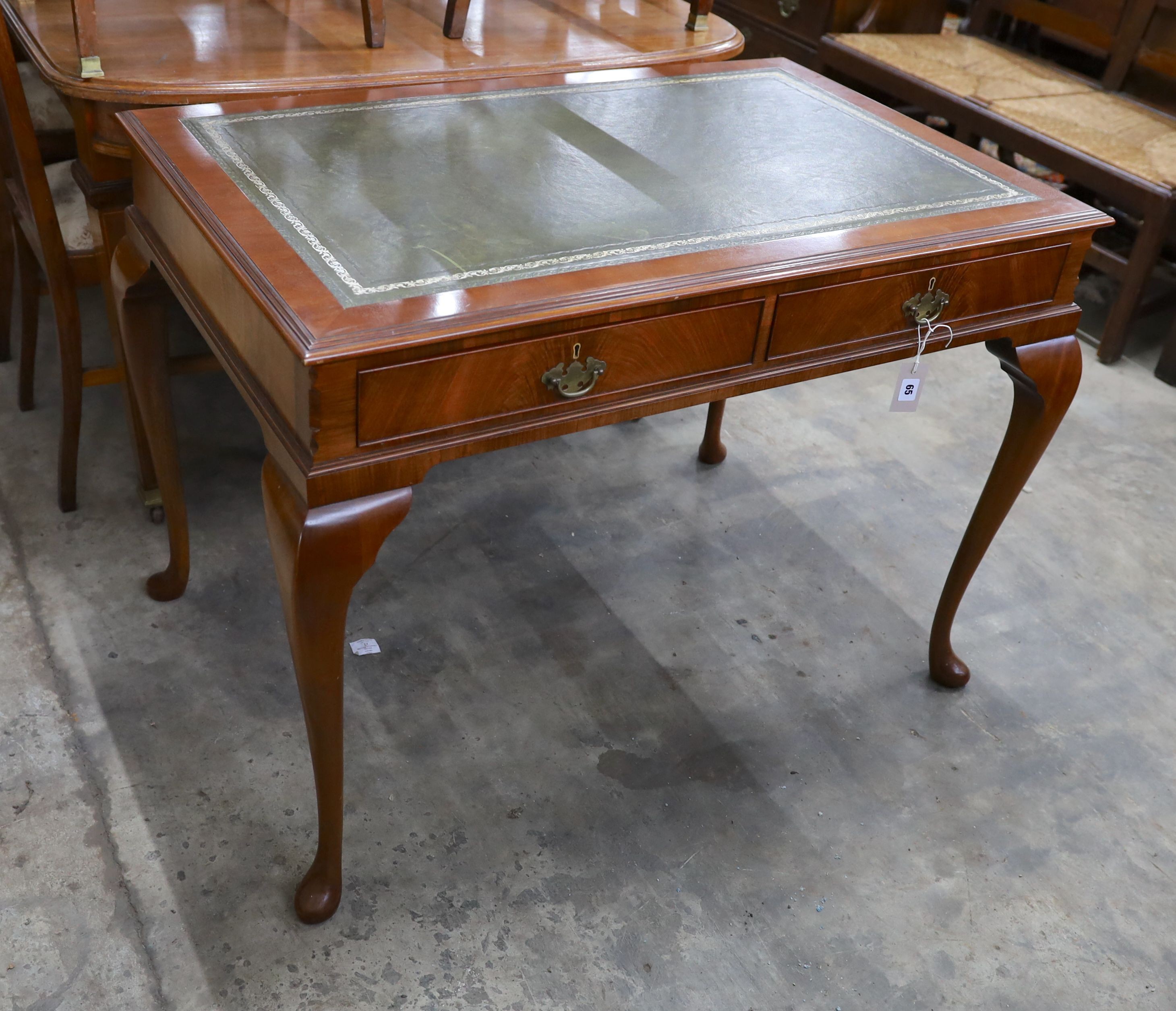 A reproduction George III style mahogany two drawer writing table, width 110cm, depth 72cm, height 77cm